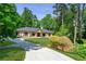 Beautifully landscaped front yard and circular driveway leading to a well-maintained single story home at 140 Emily Sw Dr, Lilburn, GA 30047