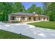 Charming single-story home featuring a concrete driveway and meticulously maintained landscaping and flowerbeds at 140 Emily Sw Dr, Lilburn, GA 30047