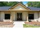 Inviting home entrance with decorative pillars, a welcome sign, and manicured flowerbeds at 140 Emily Sw Dr, Lilburn, GA 30047