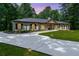 Charming single-story home featuring a concrete driveway and meticulously maintained landscaping and flowerbeds at 140 Emily Sw Dr, Lilburn, GA 30047