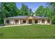 Inviting single-story home with a well-manicured lawn and attractive landscaping at 140 Emily Sw Dr, Lilburn, GA 30047