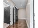 Hallway showcasing hardwood floors with multiple doors at 140 Emily Sw Dr, Lilburn, GA 30047