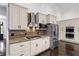 Bright kitchen with tile backsplash, white cabinets, stainless steel appliances at 140 Emily Sw Dr, Lilburn, GA 30047