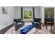 Bright living area with large window, grey seating, hardwood floors, and a decorative front door at 140 Emily Sw Dr, Lilburn, GA 30047