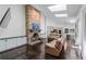 Open concept living room featuring a stone fireplace, skylights, and hardwood floors at 140 Emily Sw Dr, Lilburn, GA 30047