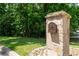 Close-up of the stone mailbox post with the house number on a lush green lawn at 140 Emily Sw Dr, Lilburn, GA 30047