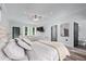 Spacious main bedroom with plush bedding, a ceiling fan, and doorway to ensuite bathroom at 140 Emily Sw Dr, Lilburn, GA 30047