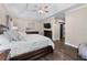 Spacious main bedroom with trey ceiling, hardwood floors, a large bed, and a television at 140 Emily Sw Dr, Lilburn, GA 30047