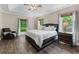 Main bedroom featuring a trey ceiling, ample windows, and a comfortable seating area at 140 Emily Sw Dr, Lilburn, GA 30047