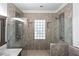 Large shower with elegant tile work, dual shower heads, and a decorative glass-block window at 140 Emily Sw Dr, Lilburn, GA 30047