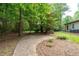 Serene side yard with a curved concrete pathway, AC unit, and easy access to the main property at 140 Emily Sw Dr, Lilburn, GA 30047
