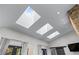 View of large skylights illuminating living area with a sliding barn door to the side at 140 Emily Sw Dr, Lilburn, GA 30047