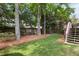 Backyard with manicured lawn, tree coverage, and a wood fence at 1887 Chamdun Pl, Brookhaven, GA 30341