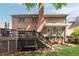 Brick home featuring an outdoor deck and nicely manicured backyard with mature landscaping at 1887 Chamdun Pl, Brookhaven, GA 30341