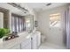Bright bathroom with marble countertops, white cabinets, a large mirror, and a neutral color scheme at 1887 Chamdun Pl, Brookhaven, GA 30341