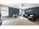 Spacious bedroom featuring blue walls, large windows, and a comfortable gray sofa with stylish decor at 1887 Chamdun Pl, Brookhaven, GA 30341