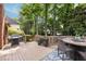 Outdoor living space boasts a wooden deck with a grill, table, and seating area at 1887 Chamdun Pl, Brookhaven, GA 30341