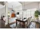 Stylish dining area with an elegant chandelier, plantation shutters, and neutral decor at 1887 Chamdun Pl, Brookhaven, GA 30341
