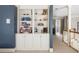 Hallway with a built-in bookcase and white trim, providing ample display and storage space at 1887 Chamdun Pl, Brookhaven, GA 30341