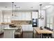 Modern kitchen with granite countertops, stainless steel appliances, and an adjacent dining area, perfect for cooking and dining at 1887 Chamdun Pl, Brookhaven, GA 30341