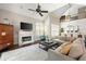 Bright living room featuring a fireplace, comfortable seating, and large windows with plantation shutters at 1887 Chamdun Pl, Brookhaven, GA 30341
