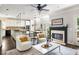 Open concept living room featuring a fireplace, kitchen, and dining area that is filled with natural light at 1887 Chamdun Pl, Brookhaven, GA 30341