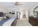 Spacious main bedroom with elegant furnishings, neutral colors, a ceiling fan, and plenty of natural light at 1887 Chamdun Pl, Brookhaven, GA 30341