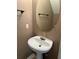 Cozy bathroom featuring a pedestal sink, oval mirror, and minimalist towel rack at 218 Osmanthus Way, Canton, GA 30114