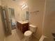 This bathroom includes a vanity sink, a toilet, and a shower with neutral finishes at 218 Osmanthus Way, Canton, GA 30114