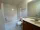 Full bathroom with tiled shower/tub combo, toilet, vanity, and large mirror at 218 Osmanthus Way, Canton, GA 30114