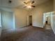 Spacious carpeted bedroom with walk-in closet and a ceiling fan at 218 Osmanthus Way, Canton, GA 30114