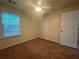 Bedroom featuring neutral carpet, a ceiling fan, and natural light from a window at 218 Osmanthus Way, Canton, GA 30114