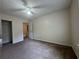 This bedroom boasts plush carpeting, ample space, and a ceiling fan for comfort at 218 Osmanthus Way, Canton, GA 30114