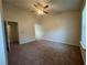 Large bedroom with a ceiling fan and neutral-toned walls at 218 Osmanthus Way, Canton, GA 30114