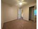 Bedroom with neutral carpet, ceiling fan, sliding closet doors, and a doorway at 218 Osmanthus Way, Canton, GA 30114