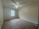 Neutral bedroom features plush carpeting, a ceiling fan, and ample natural light at 218 Osmanthus Way, Canton, GA 30114