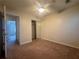 Bedroom with neutral carpet, ceiling fan, closet, and a doorway at 218 Osmanthus Way, Canton, GA 30114
