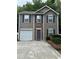 Charming two-story home featuring gray siding, stone accents, and a single-car garage at 218 Osmanthus Way, Canton, GA 30114