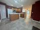 Eat-in kitchen with white appliances, tiled floor and convenient center island at 218 Osmanthus Way, Canton, GA 30114