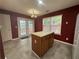 Kitchen with tile floor, island, access to the backyard and stainless steel appliances at 218 Osmanthus Way, Canton, GA 30114