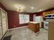 Well-lit kitchen offers access to backyard, a center island, and stainless steel appliances at 218 Osmanthus Way, Canton, GA 30114