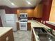 Kitchen featuring stainless steel appliances, oak cabinets, and a tile floor at 218 Osmanthus Way, Canton, GA 30114