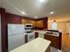 Functional kitchen with white appliances, wood cabinets, and a center island at 218 Osmanthus Way, Canton, GA 30114