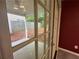 View of the patio through glass doors leading to a fenced backyard at 218 Osmanthus Way, Canton, GA 30114