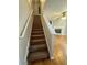 Carpeted staircase leading to the upper level of the home at 218 Osmanthus Way, Canton, GA 30114