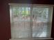 Outdoor view through window blinds overlooking the backyard at 218 Osmanthus Way, Canton, GA 30114