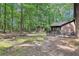 Backyard view including storage shed, screened-in porch and partial fence at 402 Summit Ridge Ter, Lawrenceville, GA 30046