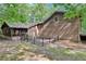 Exterior view of backyard with wooden fence, screened-in porch and wooded area at 402 Summit Ridge Ter, Lawrenceville, GA 30046