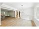 Well lit dining room featuring hardwood floors and modern chandelier at 402 Summit Ridge Ter, Lawrenceville, GA 30046