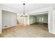 Bright dining room with hardwood floors and elegant light fixture at 402 Summit Ridge Ter, Lawrenceville, GA 30046